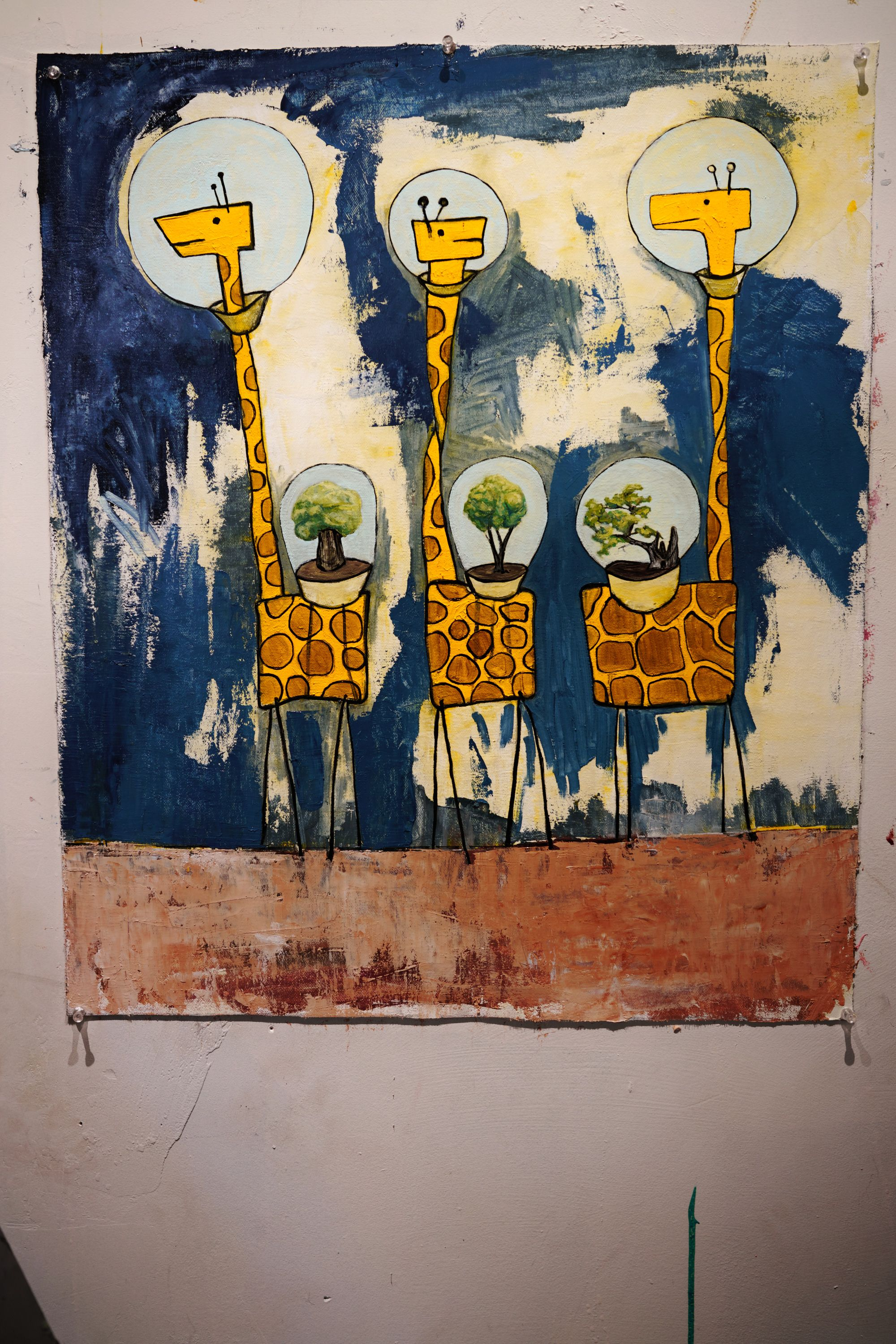 Detail view of the oil on canvas painting showing three flat-bodied yellow giraffes with glass dome respirators containing bonsai trees, against a deep blue background.
