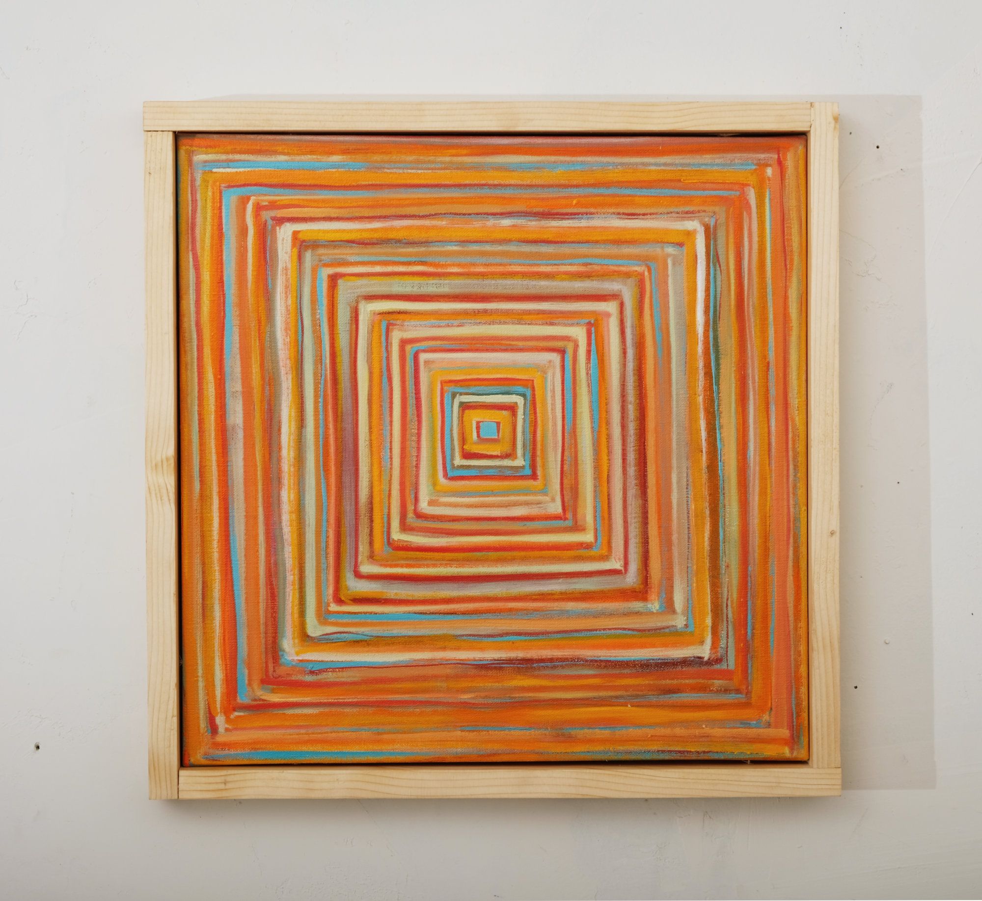 Oil painting of concentric squares in warm tones of orange, red, yellow, and turquoise blue, radiating inward to a small central square, creating a hypnotic tunnel-like composition in a light wooden frame.