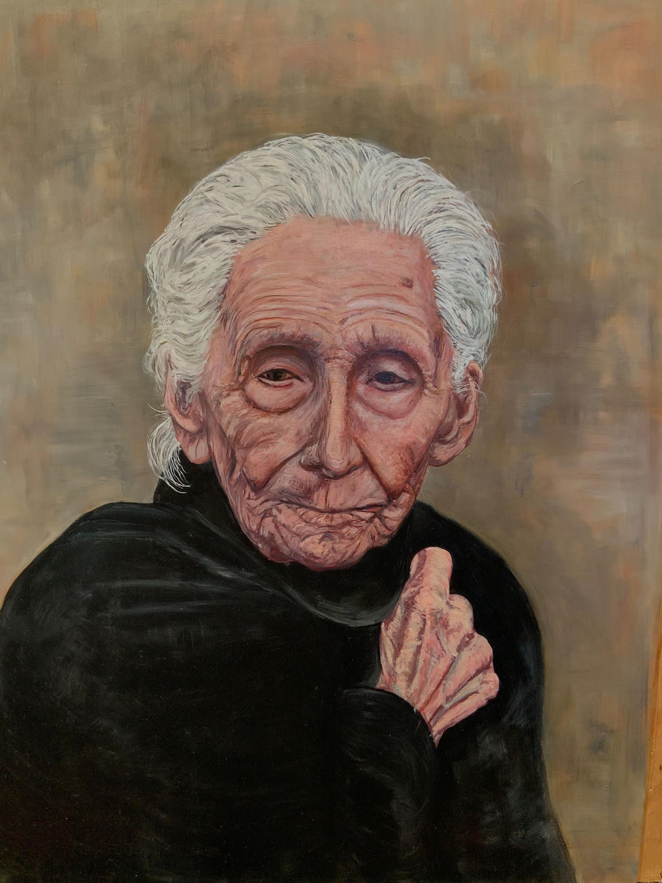 Oil on linen portrait of an elderly woman with white hair and deeply lined face, wearing a black top, one hand raised near her chest, against a warm muted brown background.